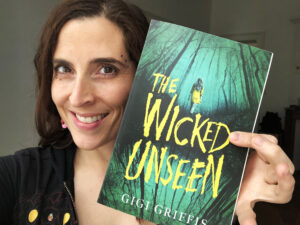 Gigi Griffis holds the paperback of The Wicked Unseen
